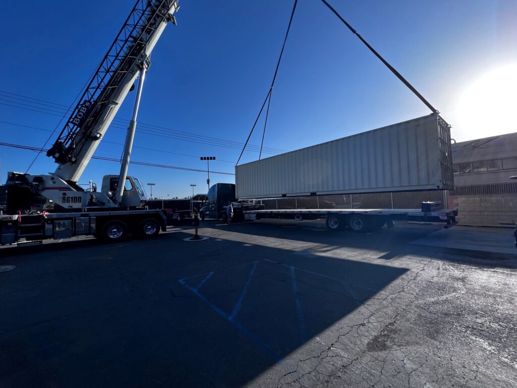 A container SCIF being loaded onto a semi truck