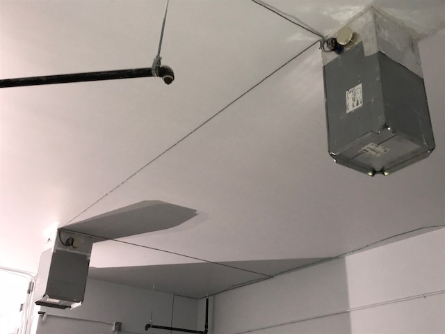 A sound masking system attached to a ceiling